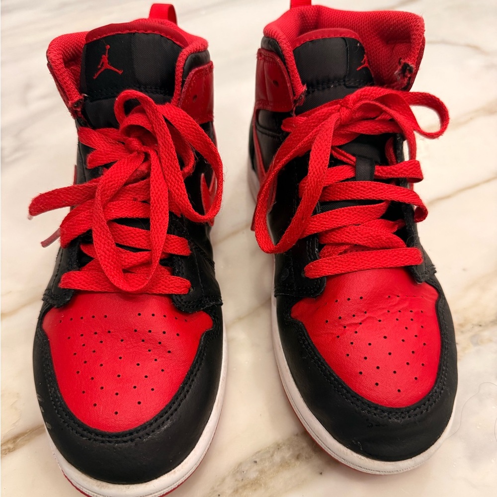 Size 3. Red and black Jordan’s. Clean but shows wear.